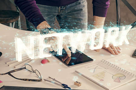 Double exposure of man's hand holding and using a digital device and data theme drawing. Technology...