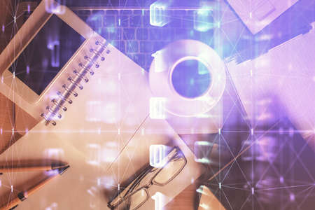 Double exposure of technology theme drawing over work table desktop. Top view. Global data analysis...