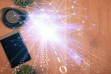 Double exposure of technology theme drawing over work table desktop. Top view. Global data analysis...