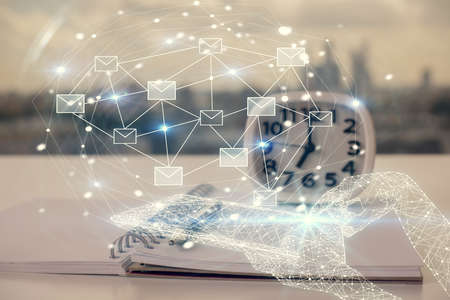Double exposure of ENVELOP flying drawings and desk with open notebook background. Concept of e-mailの写真素材