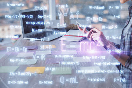 Double exposure of woman hands typing on computer and formula hologram drawing. Education concept.