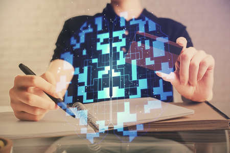 Double exposure of man hands holding a credit card and data theme drawing. E-commerce and technology concept.の写真素材