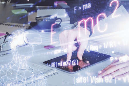 Double exposure of man's hands holding and using a phone and formulas drawing. Education concept.