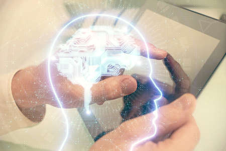Double exposure of man's hand holding and using a digital device and brain hologram drawing. Data...