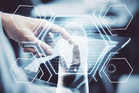 Double exposure of man's hands holding and using a digital device and fingerprint hologram drawing....