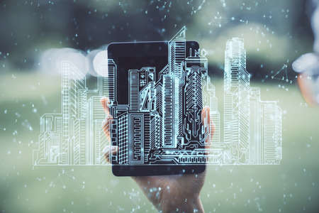 Double exposure of buildings hologram and woman holding and using a mobile device. Smart city...
