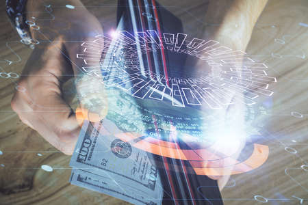Double exposure of technology drawing hologram and us dollars bills and man hands. Data conceptの写真素材