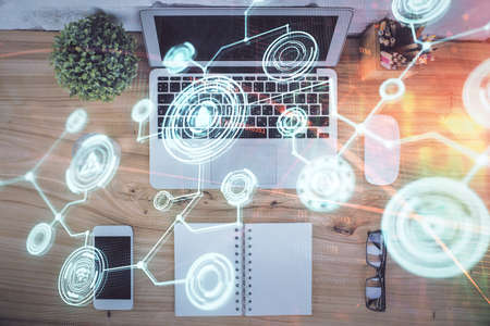Social network hologram drawings over computer on the desktop background. Top view. Multi exposure. Concept of people connection.の写真素材