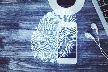Double exposure of finger print over table with phone. Top view. Concept of mobile security.の写真素材