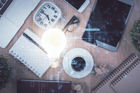 Double exposure of bulb drawing over table with phone. Top view. Concept of idea.の写真素材