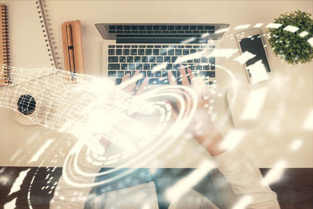 Double exposure of woman hands working on computer and data theme hologram drawing. Top View. Technology concept.の写真素材