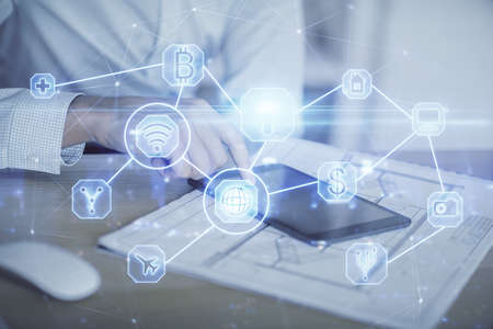 Double exposure of man's hands holding and using a phone and social network theme drawing.