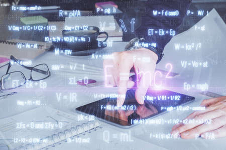 Double exposure of man's hands holding and using a phone and formulas drawing. Education concept.