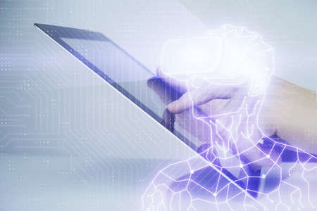 Double exposure of man's hands holding and using a digital device and AR glasses drawing. Virtual...