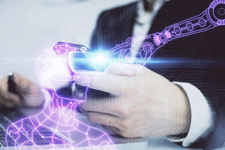 Double exposure of man's hands holding and using a digital device and AR glasses drawing. Virtual...