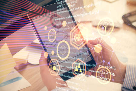 Multi exposure of man's hands holding and using a digital device and data theme drawing. Innovation...