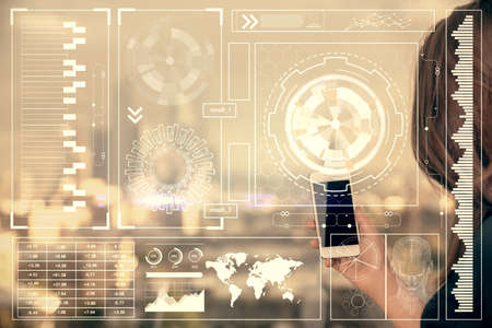 Double exposure of technology sketch hologram and woman holding and using a mobile device.の写真素材