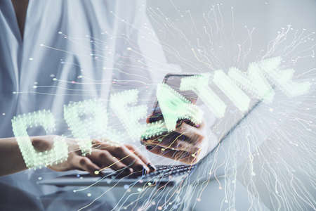 Double exposure of creative hologram and woman holding and using a mobile device. Start up concept.の写真素材