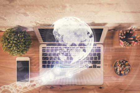 Double exposure of map hologram drawing over study table background with computer. Concept of...