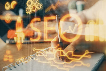 Double exposure of SEO drawing over people taking notes background. Concept of search optimizationの写真素材