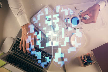 Double exposure of man's hands typing over computer keyboard and data theme hologram drawing. Top view. Technology concept.の写真素材
