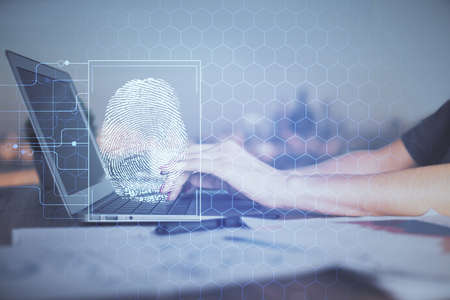 Double exposure of woman hands typing on computer and fingerprint drawing. Security concept.の写真素材