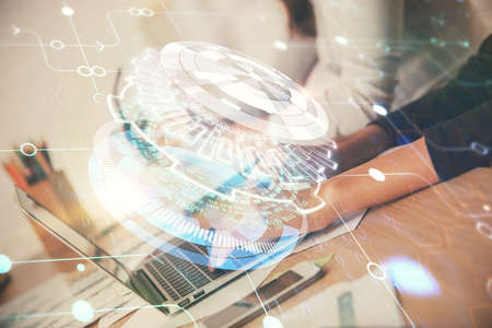 Double exposure of woman hands working on computer and data theme hologram drawing. Tech concept.の写真素材
