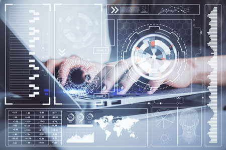Double exposure of woman hands working on computer and data theme hologram drawing. Tech concept.の写真素材