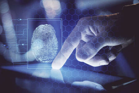 Double exposure of man's hands holding and using a digital device and fingerprint hologram drawing....