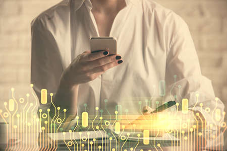 Double exposure of technology sketch hologram and woman holding and using a mobile device. Ai...