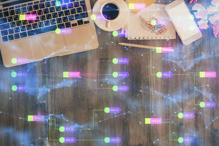 Multi exposure of data theme drawing hologram over topview work desk background with computer....