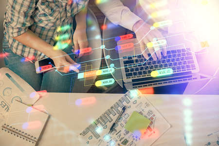 Double exposure of man and woman working together and data theme hologram drawing. Computer...