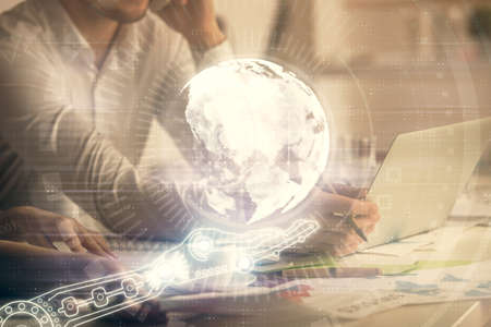 Double exposure of man and woman working together and technology theme world map drawing hologram....