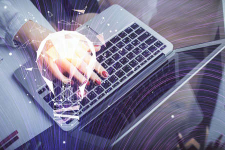Double exposure of woman hands typing on computer and light bulb drawing. Idea concept.