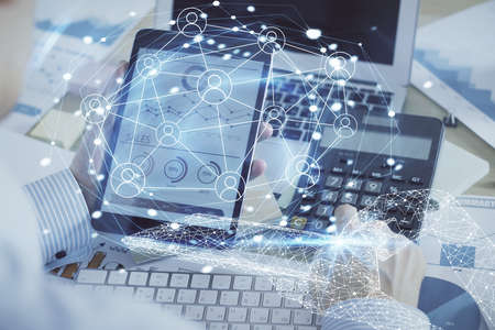 Double exposure of man's hands holding and using a phone and social network theme drawing.