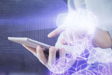 Double exposure of man's hands holding and using a digital device and AR glasses drawing. Virtual reality concept.の写真素材