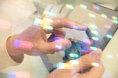 Multi exposure of man's hand holding and using a digital device and data theme drawing. Innovation concept.の写真素材