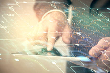 Multi exposure of man's hand holding and using a digital device and data theme drawing. Innovation...