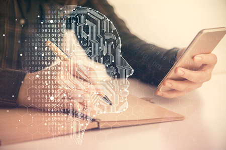 Double exposure of brain sketch hologram and woman holding and using a mobile device.の写真素材