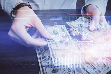 Double exposure of technology drawing hologram and us dollars bills and man hands. Data concept