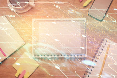 Double exposure of technology theme drawing over work table desktop. Top view. Global data analysis...