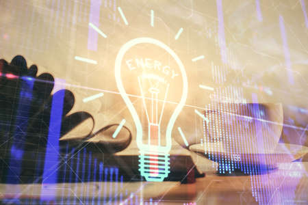 Double exposure of bulb drawing and desktop with coffee and items on table background. Concept of ideas.の写真素材