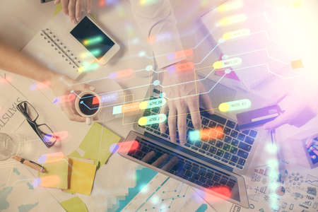 Double exposure of man's hands typing over computer keyboard and data theme hologram drawing. Top view. Technology concept.の写真素材