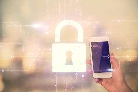 Double exposure of lock sketch hologram and woman holding and using a mobile device. Security iT conceptの写真素材