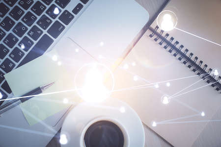 Social network hologram drawings over computer on the desktop background. Top view. Double exposure.の写真素材