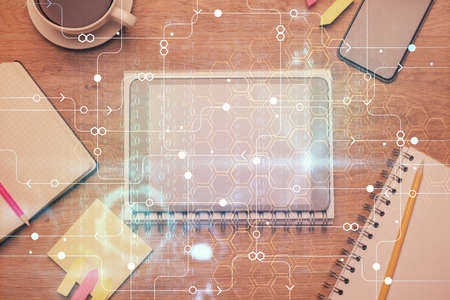 Double exposure of technology theme drawing over work table desktop. Top view. Global data analysis...