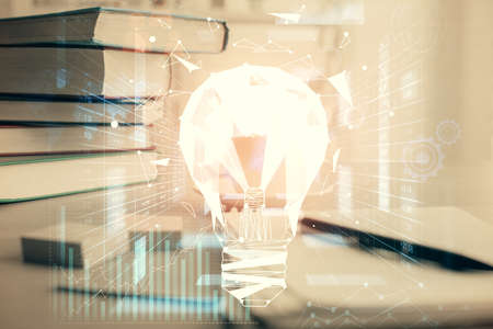 Double exposure of bulb drawing and desktop with coffee and items on table background. Concept of ideas.の写真素材