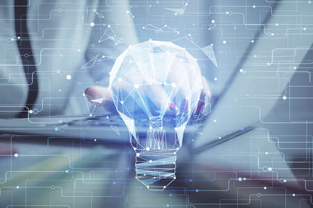 Double exposure of woman hands typing on computer and light bulb drawing. Idea concept.の写真素材