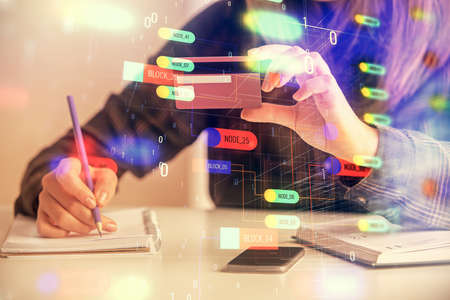 Double exposure of woman on-line shopping holding a credit card and data theme hologram drawing....