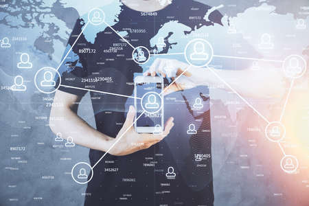 Double exposure of man's hands holding and using a phone and social network theme drawing.